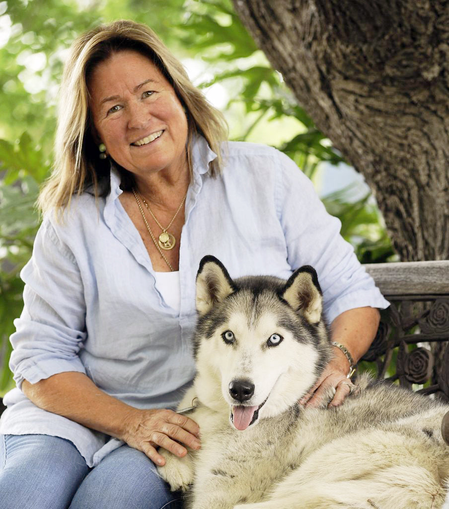 Antoine the husky sitting with Janet curran